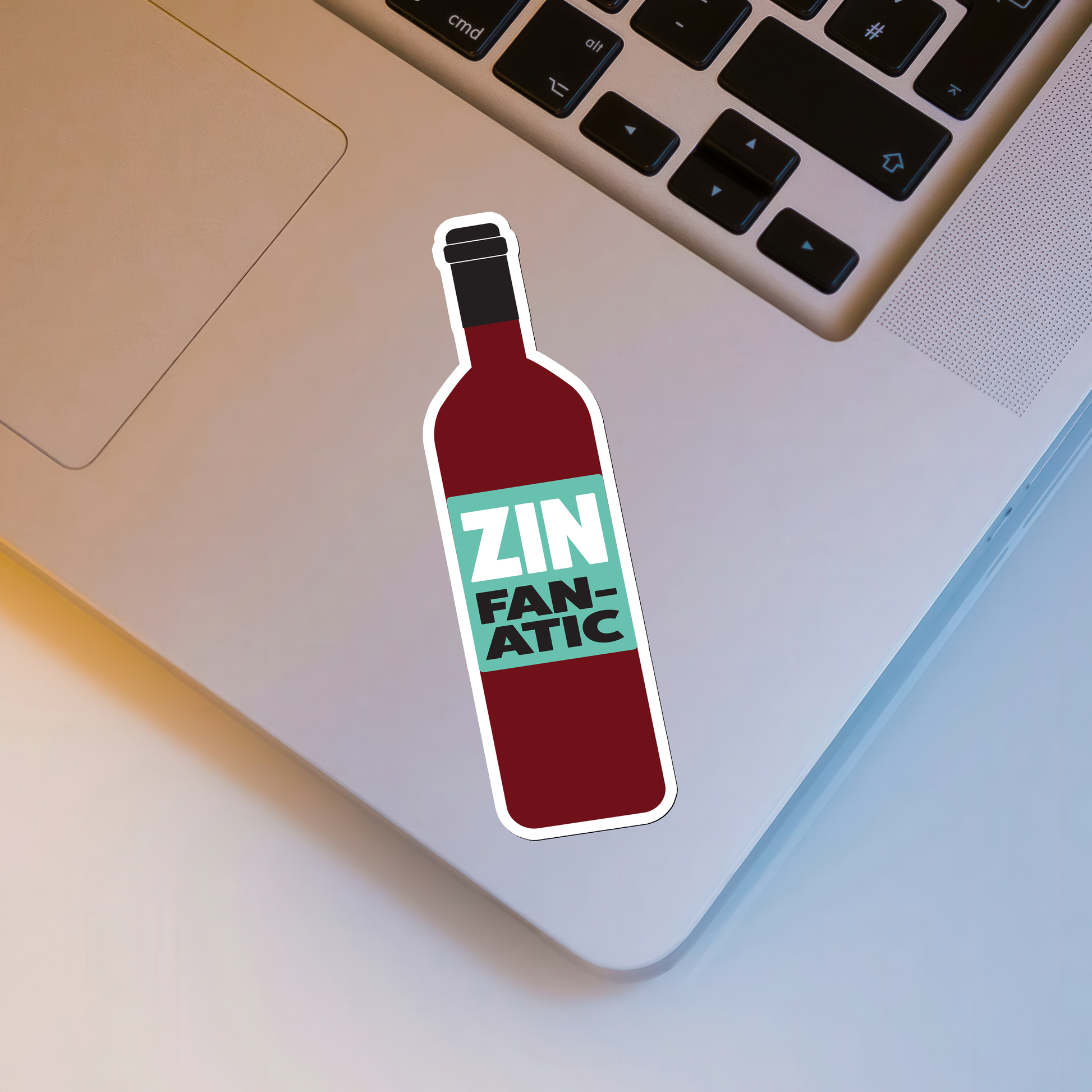 Sticker of a wine bottle labeled 'Zin Fanatic' on a laptop